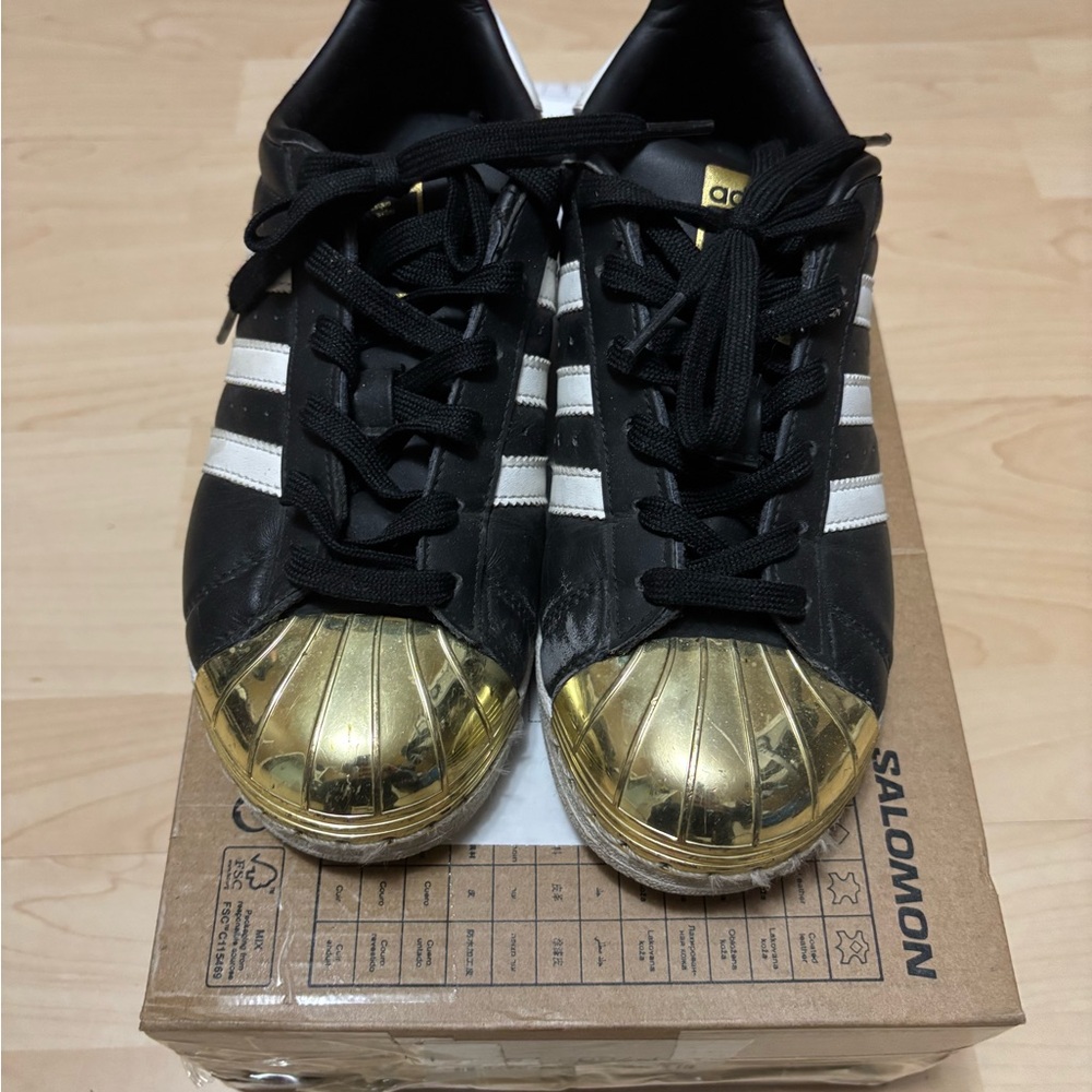 Women Adidas Black and Gold Shell Toe Sneakers